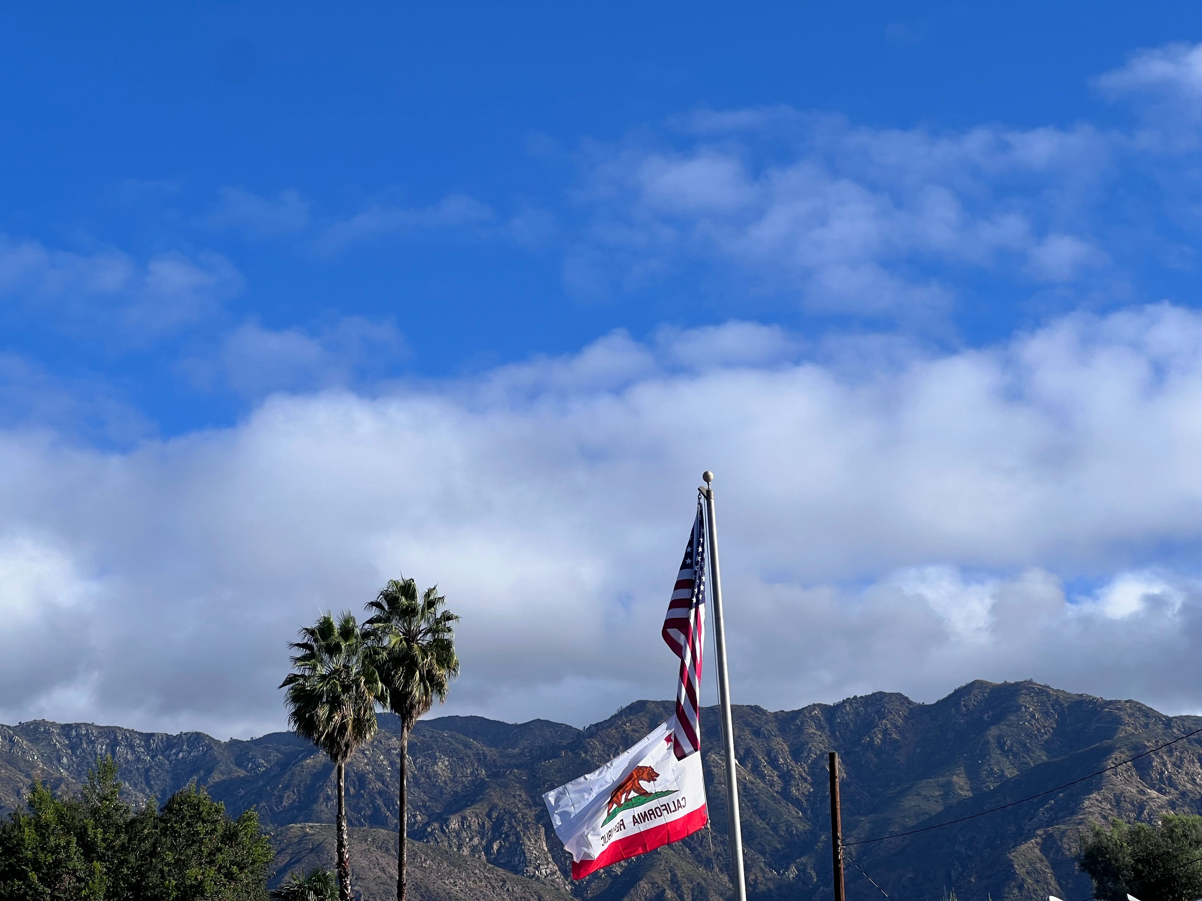 Foothills with flags and blue sky